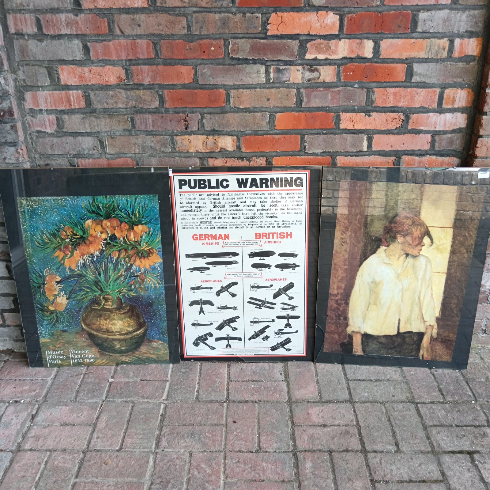 Vintage gallery poster prints including public warning and Van Gogh art.
