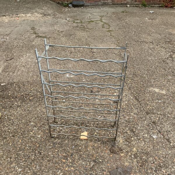 Vintage galvanised bottle rack for storage and display.