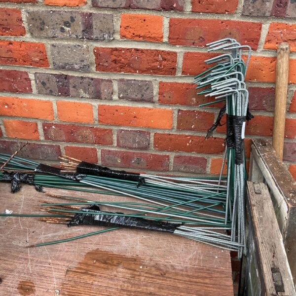 Metal garden frame parts for plant support and edging.