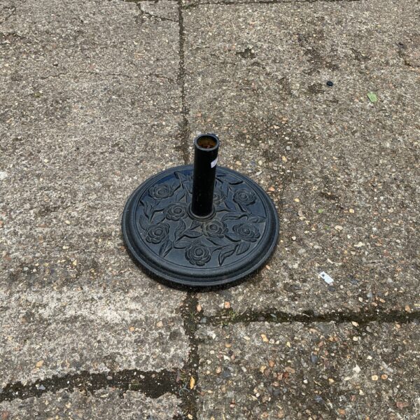 Metal garden parasol base with floral design for patio umbrellas.