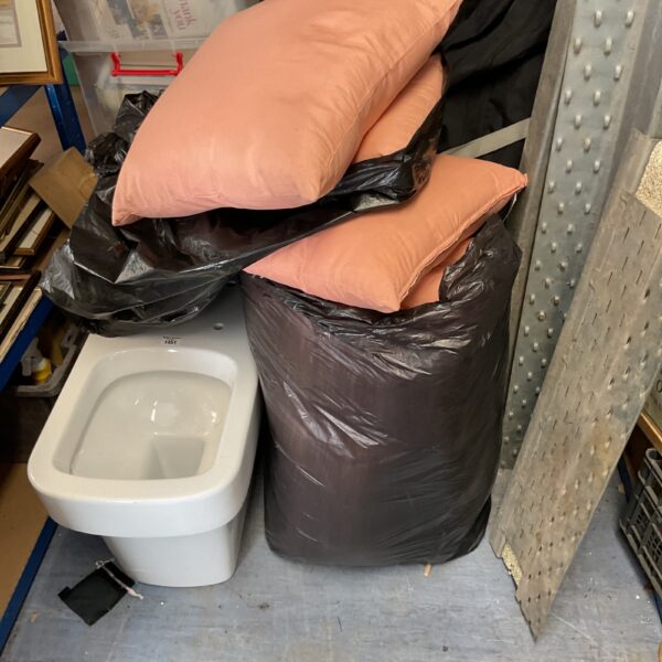 Pink waterproof garden pillows in plastic bags.