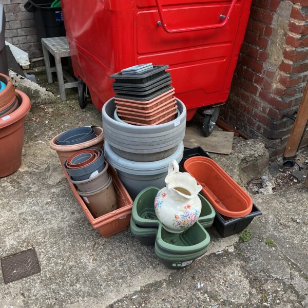 Assorted garden planters and pots in a mixed lot.