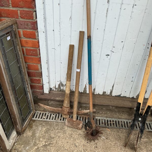 Vintage garden tools lot including sledgehammer, pickaxe and edger.