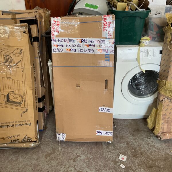 Geberit installation system kit with packaging visible in a cluttered space.