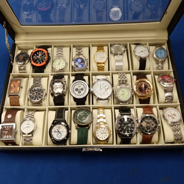 Gents watch collection in a display case, including Bench and Fossil.