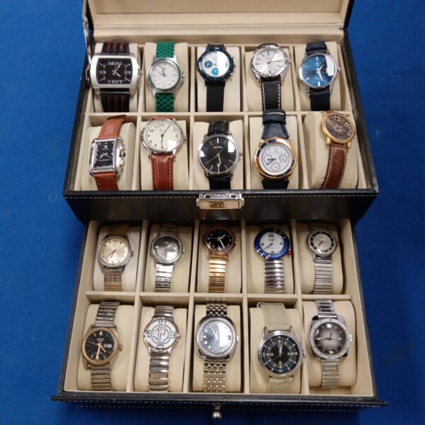 Gents watch collection in a display case, including Ingersoll and Avia brands.