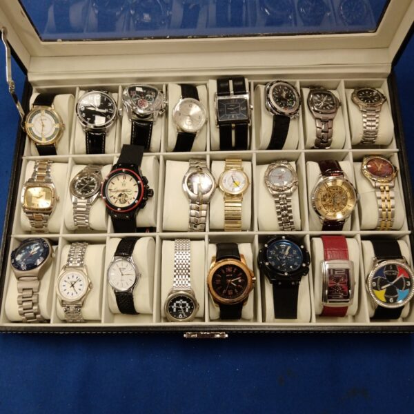 Gents watch collection displayed in a case, including Jaguar and Avia.