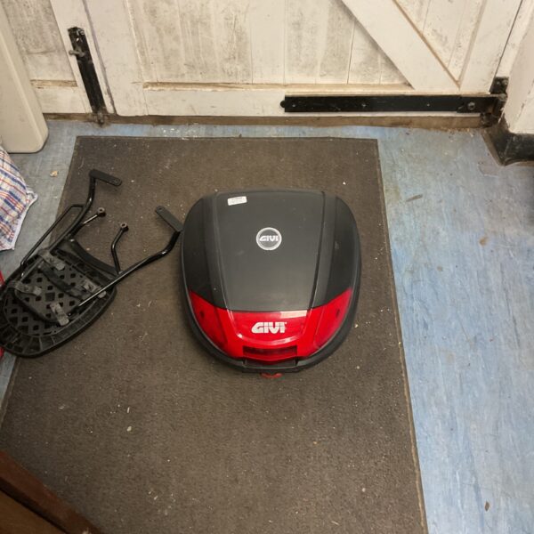 Red Givi E300N2 top box for motorcycle storage.