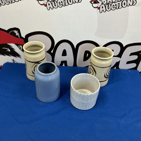 Lot of four handcrafted glazed ceramic vases for home decor.