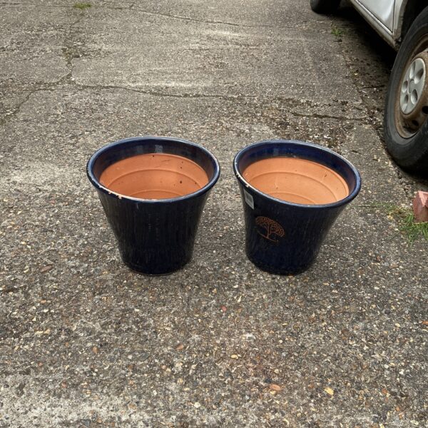 Two blue glazed terracotta garden pots for outdoor plants.