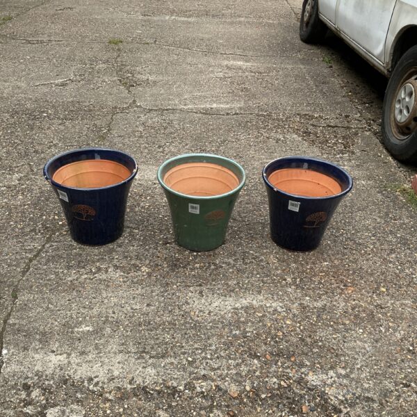 Lot of three glazed terracotta garden pots for outdoor use.