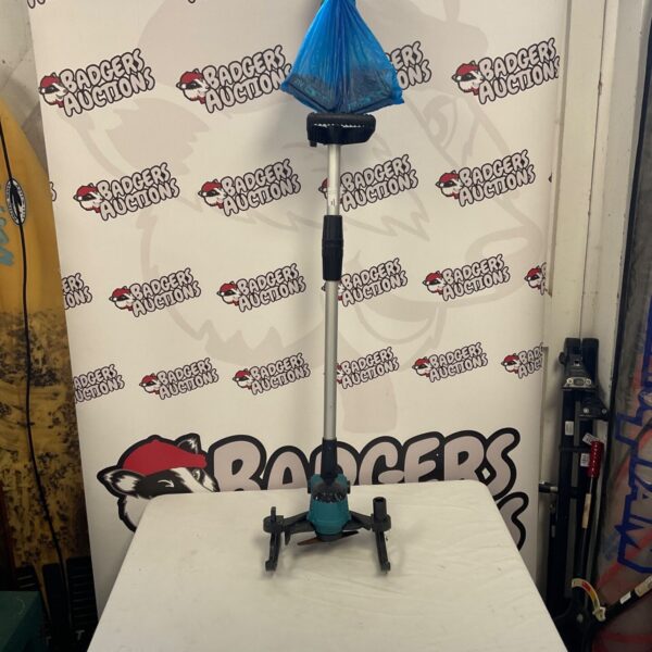 Blue and silver grass strimmer with batteries and charger.