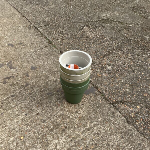 Green plastic balcony planter for outdoor gardening.