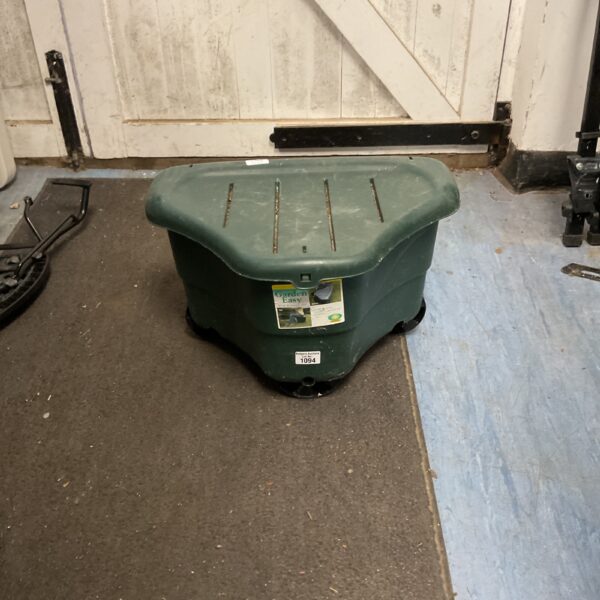 Green plastic garden storage box with hinged lid.
