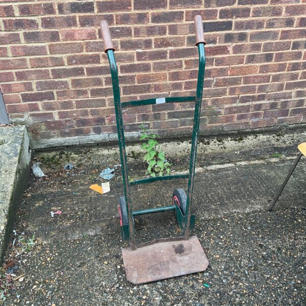 Green sack barrow for moving heavy loads in the garden.