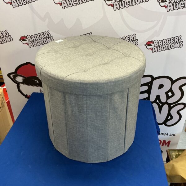 Grey padded storage stool with lift-up lid.