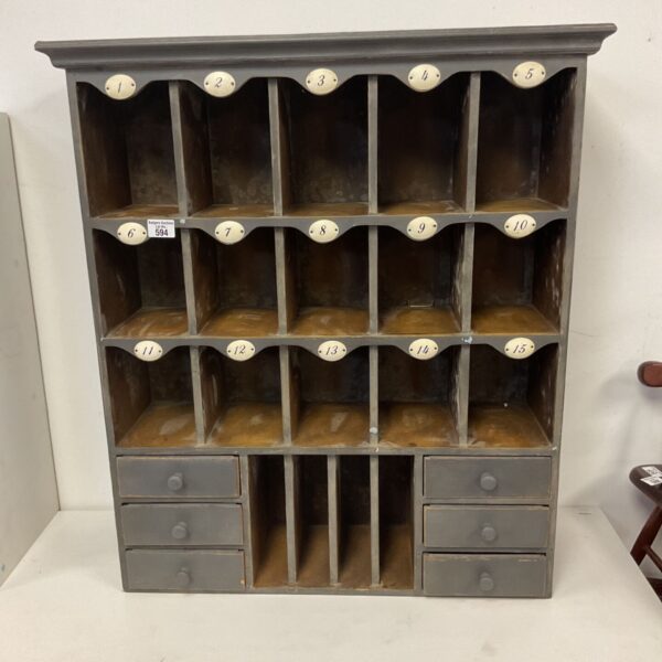 Vintage grey wooden wall storage cabinet with numbered cubbies.