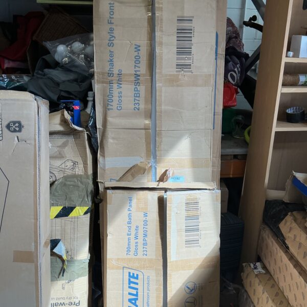 Four white Halite bathroom wall panels in original packaging.
