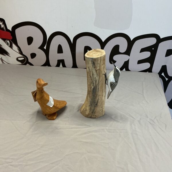 Pair of hand-carved wooden bird ornaments for rustic home decor.