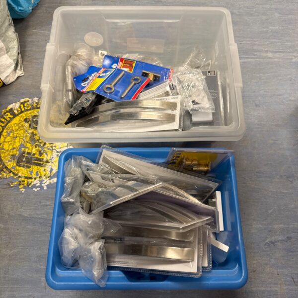 Assorted hardware lot with door handles and metal fittings.