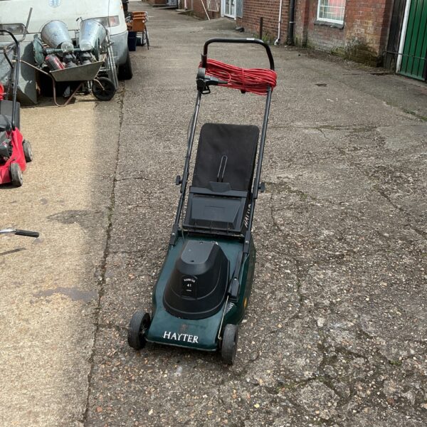 Hayter Harrier 41 electric lawnmower in a garden setting.