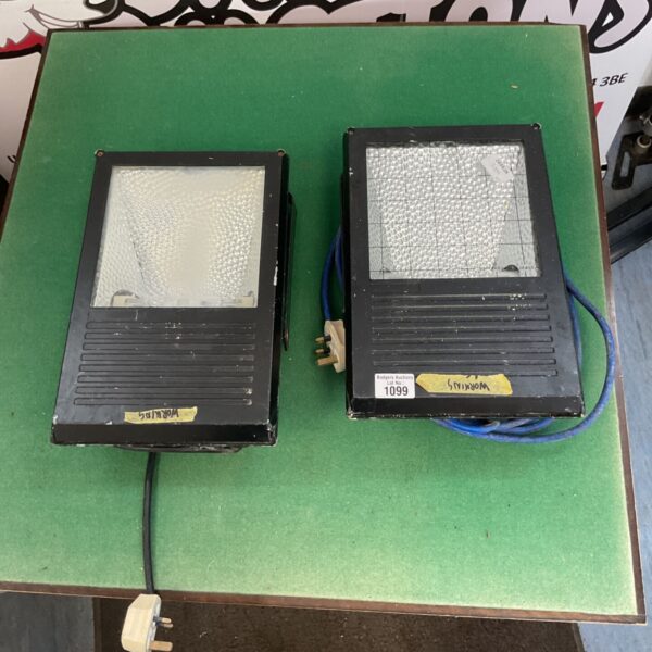 Heavy-duty work light with protective cage, suitable for construction.