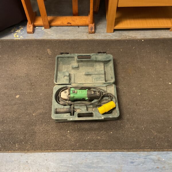 Used Hitachi angle grinder in a green carrying case.