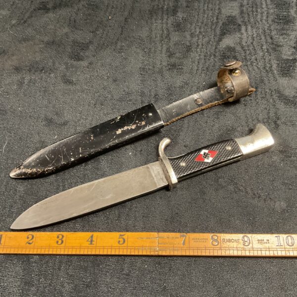 WWII Hitler Youth dagger with steel blade and dark handle.