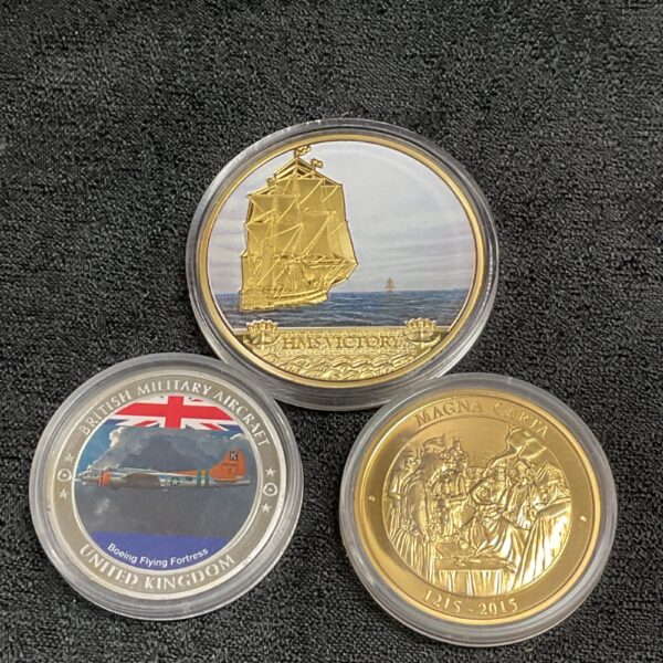 Golden HMS Victory commemorative coin, detailed British history collectible.