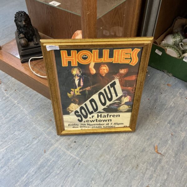 Framed vintage Hollies tour poster, music memorabilia collectible.