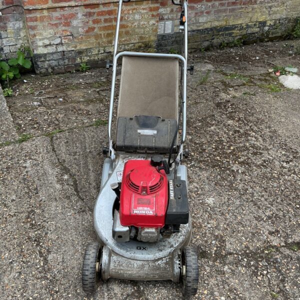 Honda HR194 petrol lawnmower in a garden setting.