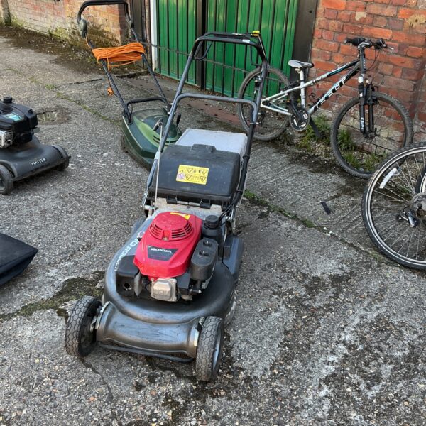 Used Honda petrol lawn mower with roller, ideal for garden maintenance.