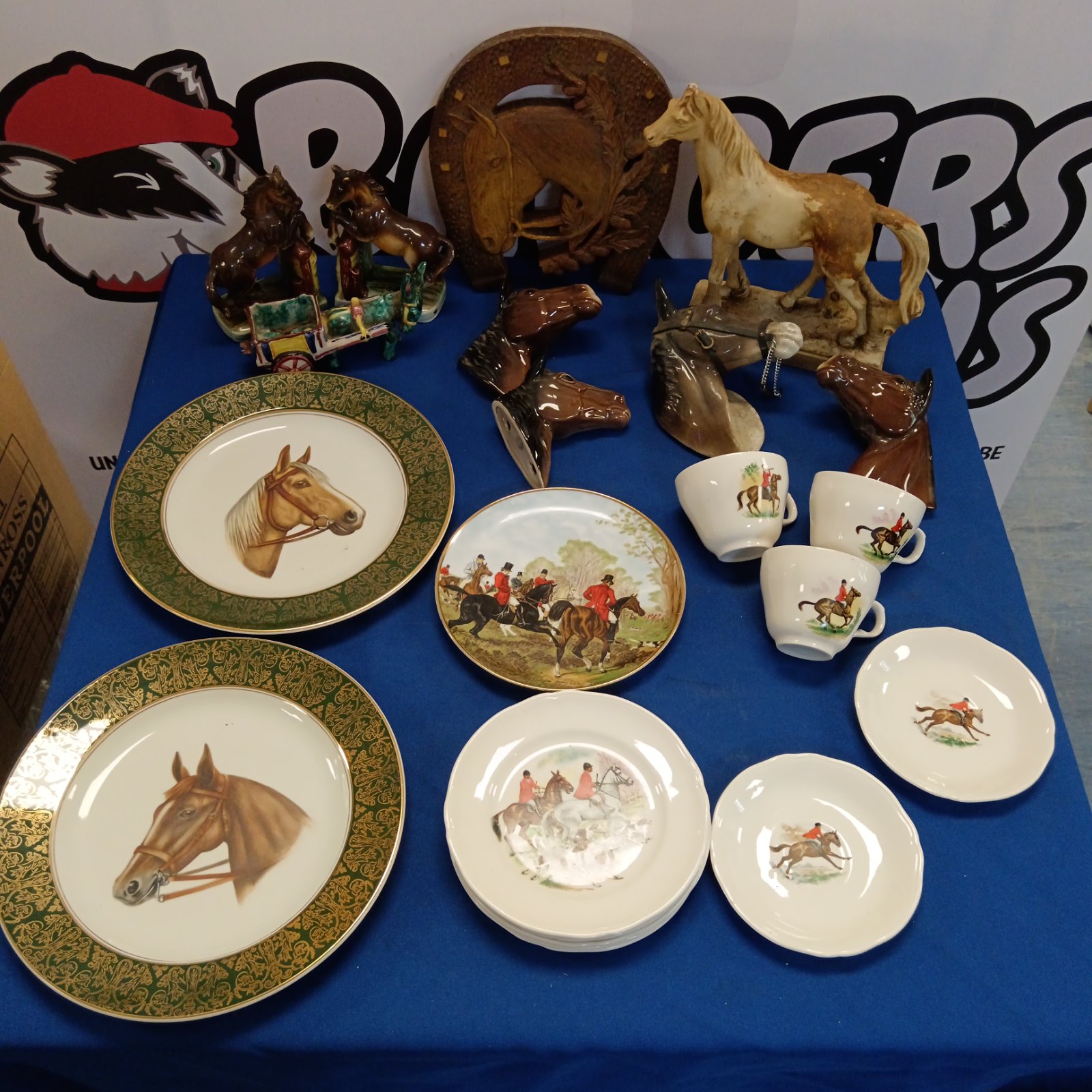 Display of vintage horse collectibles including plates and figurines.