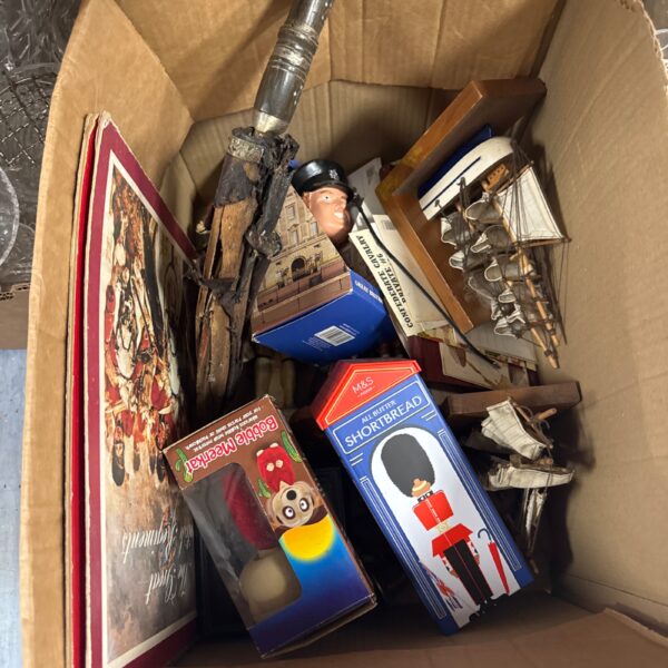 House clearance lot with vintage toys and ephemera inside a cardboard box.