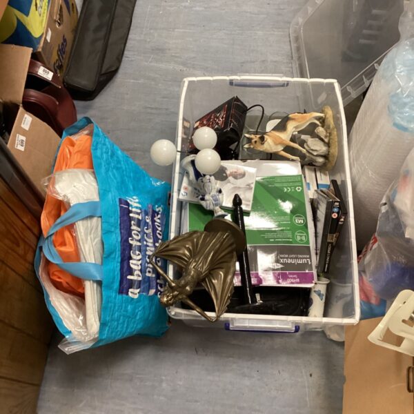 Mixed house clearance lot with blanket, DVDs, and sensor.