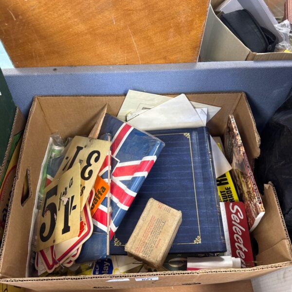 House clearance lot with photo albums and plastic signs.