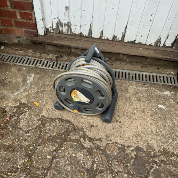 Hozlock garden hose reel with hosepipe wound around it.