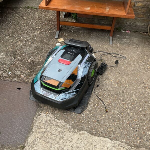 Husqvarna Automower robot lawn mower with charging station in garden.
