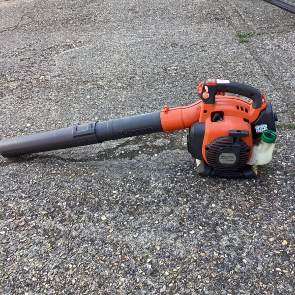 Orange Husqvarna petrol leaf blower for garden leaf clearing.