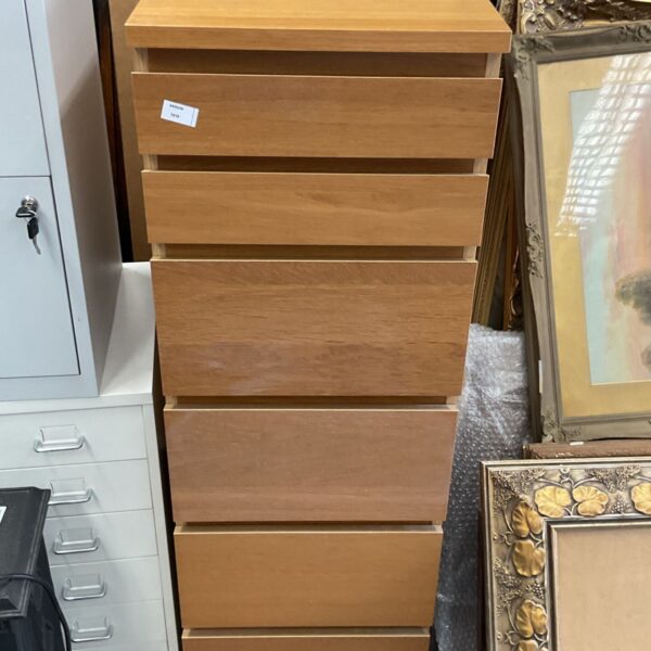 Light wood IKEA 6 drawer chest of drawers for bedroom storage.