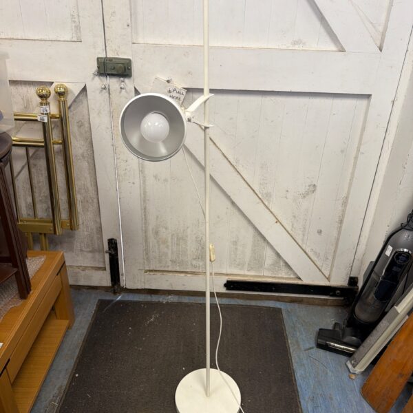 Modern IKEA HÅRSLINGA floor lamp with adjustable spotlight head.