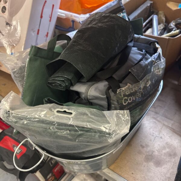 Tin bathtub with assorted tarpaulins contents