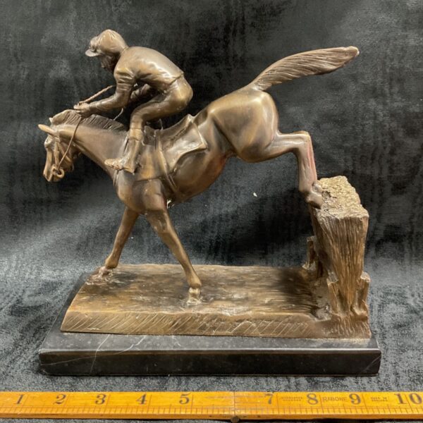 Bronze jockey and racehorse sculpture on marble plinth