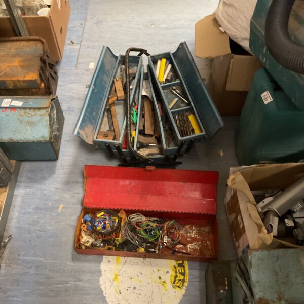 Red metal toolbox contains a variety of loose electrical components and wiring along with a blue tool box containing drill bits, screwdrivers, pliers