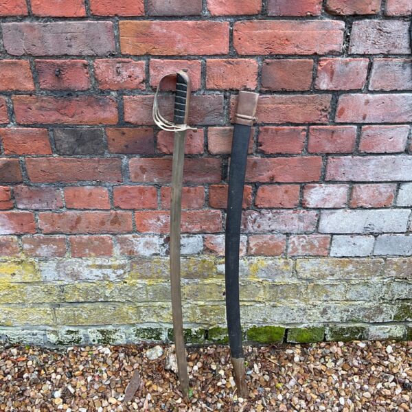 Antique Indian military sword with curved blade and wire-wrapped hilt.