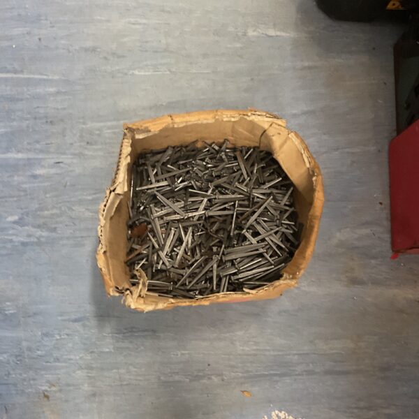 Box of industrial fasteners and metal screws for DIY projects.