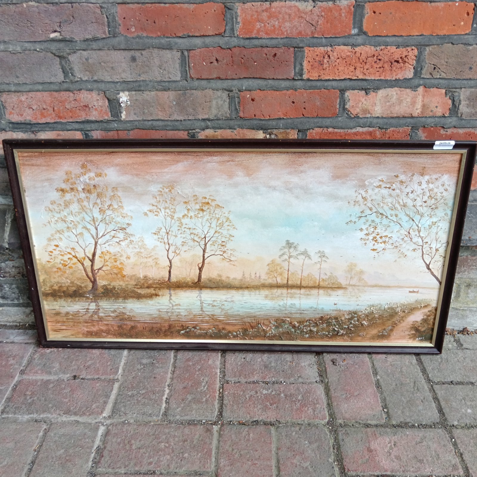 Vintage J Ray oil painting of a peaceful lakeside landscape.