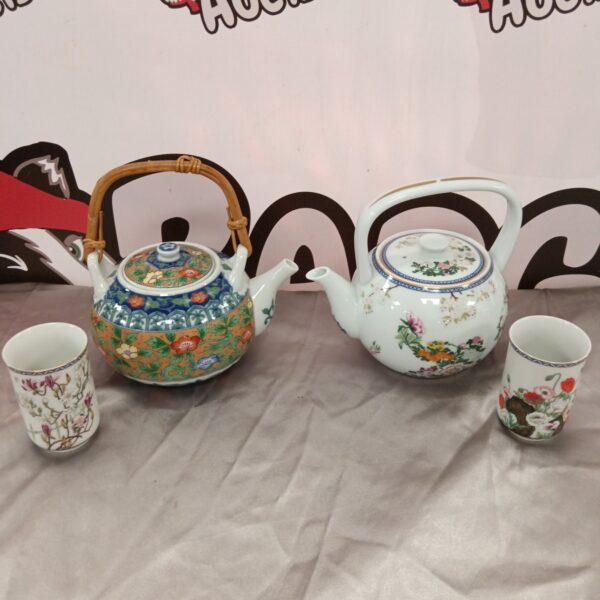 Vintage Japanese porcelain teapots with colourful floral designs.
