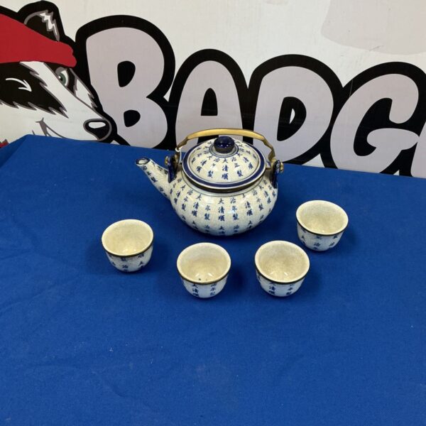 Vintage Japanese tea set with blue and white teapot and cups.