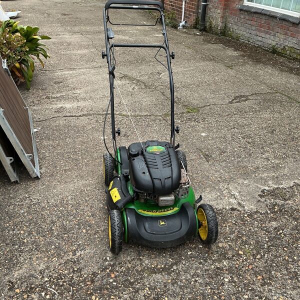 Green and yellow John Deere petrol lawnmower in a garden setting.